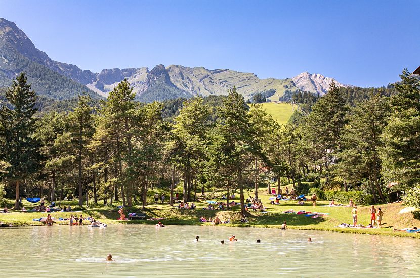 The Imst natural lake surrounded by trees